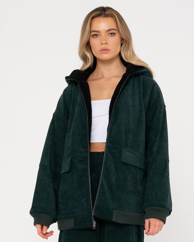 Woman wearing Gables Cord Reversible Jacket in Green Gables