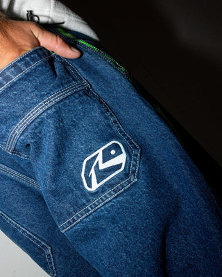 Man wearing Reflekt Baggy Jean in Deep Sea Blue / Lime