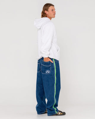 Man wearing Reflekt Baggy Jean in Deep Sea Blue / Lime