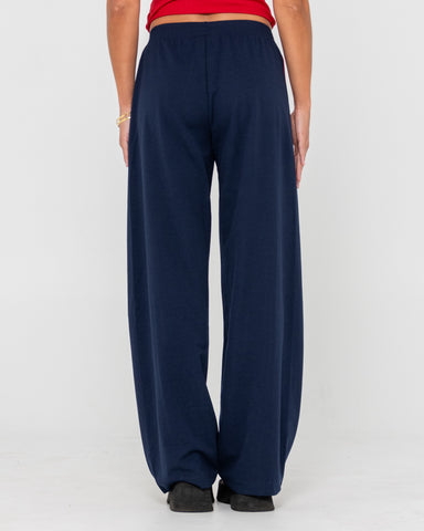 Woman wearing Bronson Low Rise Trackpant in Navy Blue