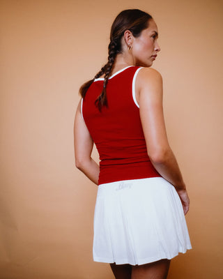 Woman wearing Luv One Pleated Low Rise Mini Skirt in Off White