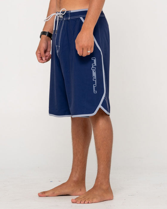 man-wearing-voltron-fixed-waist-boardshort-in-dark-blue