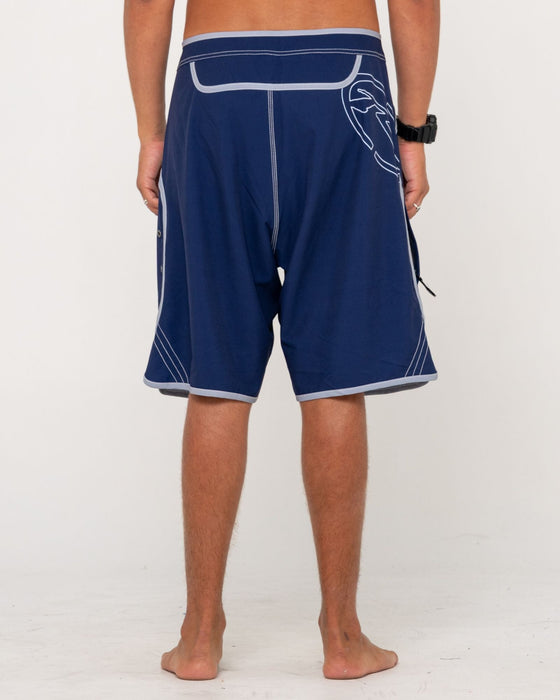 man-wearing-voltron-fixed-waist-boardshort-in-dark-blue