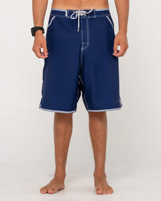 man-wearing-voltron-fixed-waist-boardshort-in-dark-blue