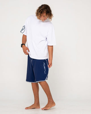Man wearing Voltron Fixed Waist Boardshort in Dark Blue