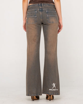 Woman wearing Lucky Number Low Rise Flare Jeans in Rusty Overdye