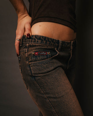 Woman wearing Lucky Number Low Rise Flare Jeans in Rusty Overdye