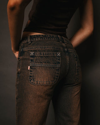 Woman wearing Lucky Number Low Rise Flare Jeans in Rusty Overdye