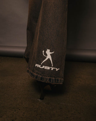 Woman wearing Lucky Number Low Rise Flare Jeans in Rusty Overdye