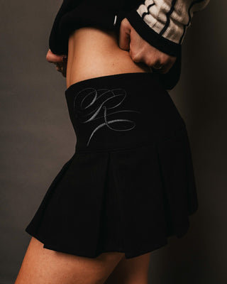 Woman wearing Gemnani Low Rise Pleated Skirt in Black