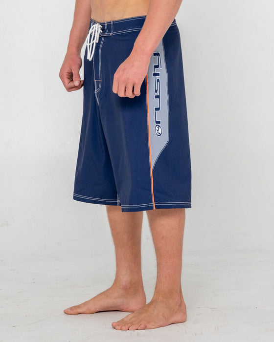 man-wearing-ghostface-fixed-waist-boardshort-in-dark-blue