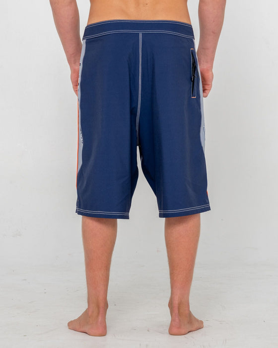 man-wearing-ghostface-fixed-waist-boardshort-in-dark-blue