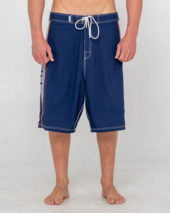 man-wearing-ghostface-fixed-waist-boardshort-in-dark-blue