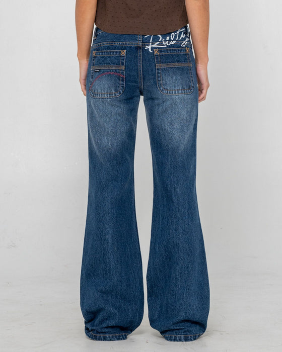 woman-wearing-shorty-freida-flare-low-rise-jeans-in-blasted-deep-sea-blue