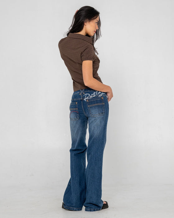 woman-wearing-shorty-freida-flare-low-rise-jeans-in-blasted-deep-sea-blue