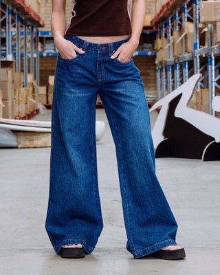 Woman wearing Colour Me Wendy Wide Low Rise Jeans in Blasted Deep Sea Blue