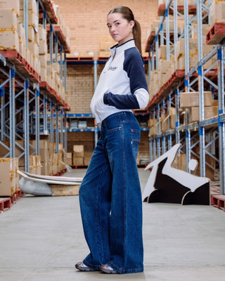 Woman wearing Colour Me Wendy Wide Low Rise Jeans in Blasted Deep Sea Blue