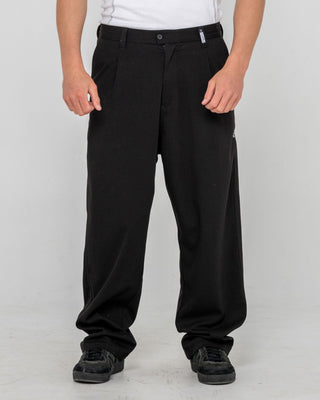 Man wearing Jasper Baggy Pleated Suit Pant in Black