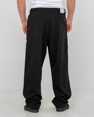 Man wearing Jasper Baggy Pleated Suit Pant in Black