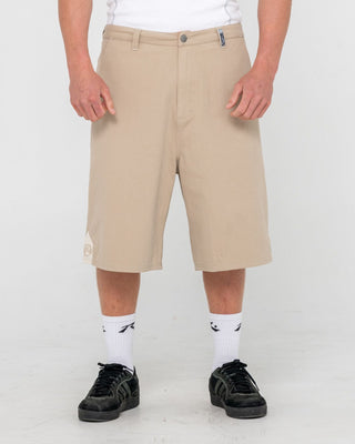 Man wearing Strikewear Baggy Twill Short in Abbey Stone