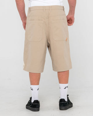 Man wearing Strikewear Baggy Twill Short in Abbey Stone