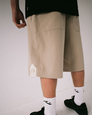 Man wearing Strikewear Baggy Twill Short in Abbey Stone