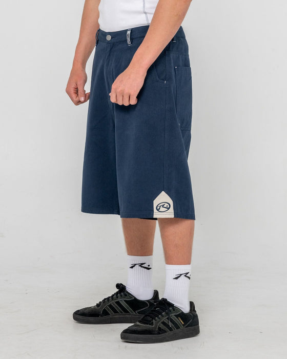 man-wearing-strikewear-baggy-twill-short-in-dark-blue