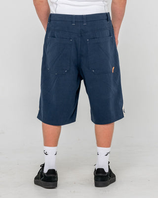 Man wearing Strikewear Baggy Twill Short in Dark Blue
