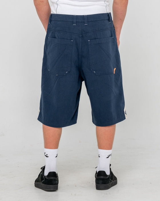 man-wearing-strikewear-baggy-twill-short-in-dark-blue