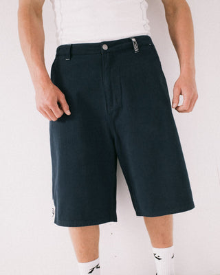Man wearing Strikewear Baggy Twill Short in Dark Blue