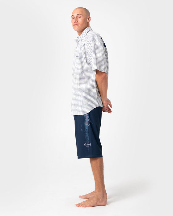 man-wearing-morning-glory-fixed-waist-boardshort-in-navy-blue