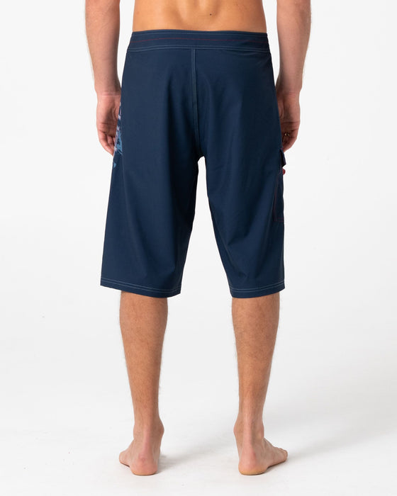 man-wearing-morning-glory-fixed-waist-boardshort-in-navy-blue