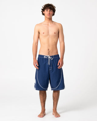 man-wearing-deathroll-hybrid-waist-boardshort-in-dark-blue