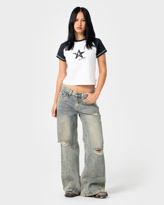 Woman wearing Starred Devil Raglan Baby Tee in White / Washed Black