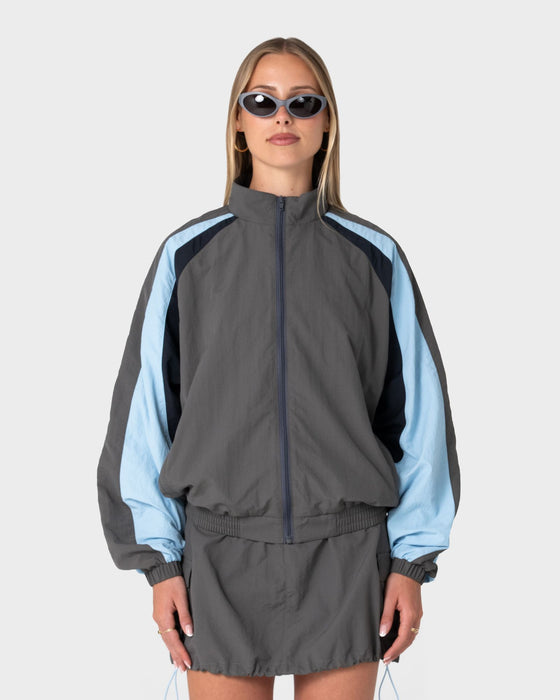 woman-wearing-breezy-wind-cheater-zip-through-jacket-in-grey-blue