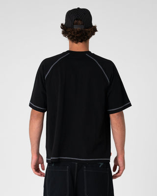 Man wearing Riddle Me This Short Sleeve Tee in Black