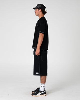 Man wearing Riddle Me This Short Sleeve Tee in Black