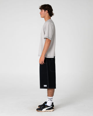 Man wearing Riddle Me This Short Sleeve Tee in Stone Grey