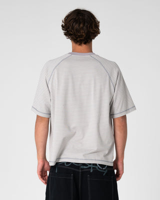 Man wearing Riddle Me This Short Sleeve Tee in Stone Grey