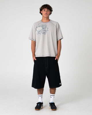 Man wearing Riddle Me This Short Sleeve Tee in Stone Grey