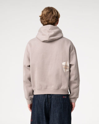 Man wearing Uncut Gems Hooded Fleece in Stone