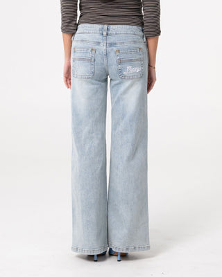 Woman wearing Lori Super Low Rise Wide Leg Denim Jean in Worn Out
