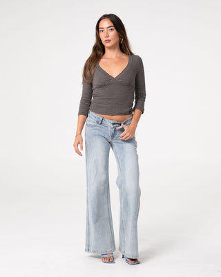 Woman wearing Lori Super Low Rise Wide Leg Denim Jean in Worn Out