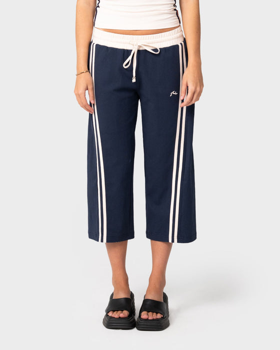 woman-wearing-maneater-low-rise-capri-track-pant-in-navy-blue