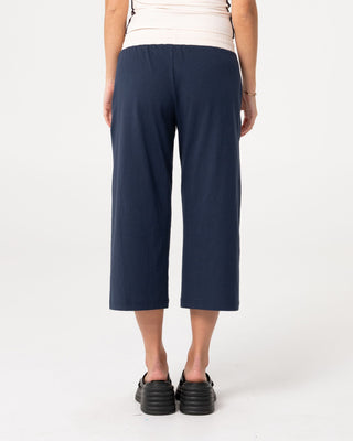 Woman wearing Maneater Low Rise Capri Track Pant in Navy Blue