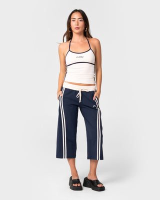 Woman wearing Maneater Low Rise Capri Track Pant in Navy Blue