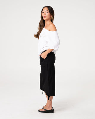 Woman wearing Kick It Cut Off Shoulder Tee in Vintage White