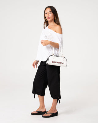 Woman wearing Kick It Cut Off Shoulder Tee in Vintage White