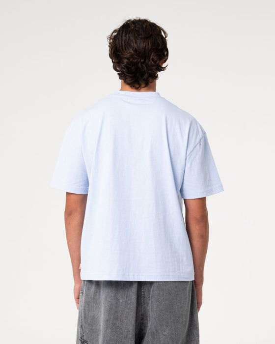 man-wearing-big-ticket-short-sleeve-tee-in-ice-blue