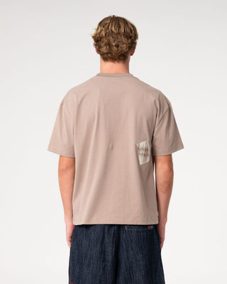 Man wearing Uncut Gems Short Sleeve Tee in Mushroom